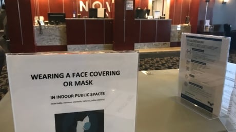 People in Yellowknife can self-isolate at the Chateau Nova Hotel, where they check in and receive information about isolating, three meals a day, snacks, laundry detergent, and more. Face mask sign
