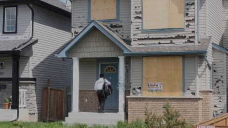 An unidentified man enters a hail damaged house in the northeast community of Saddleridge. The June 13 storm resulted in 70,000 insurance claims and the costliest hail storm in Canadian history. Saddleridge hail damage