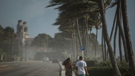 Sea spray, sand and winds sweep across South Ocean Boulevard in Palm Beach, Fla., as Palm Beach County readies for Hurricane Isaias on Saturday, Aug. 1, 2020. Isaias snapped trees and knocked out power as it blew through the Bahamas on Saturday and churned toward the Florida coast, where it is threatening to complicate efforts to contain the coronavirus in a hot spot. Tropical Weather Florida