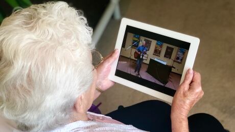 Alice Cowell watches Wes Froese perform on her iPad after in-person concerts were cancelled due to the COVID-19 pandemic. Alice Cowell