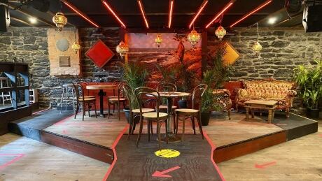 Seating now covers the stage at l'Esco, with tape on the floor helping direct foot traffic. The bar, known as a hub for local bands, is now trying to figure out how to put on shows again. Venues work to adapt to pandemic as government aid alone won't keep them afloat Image 1