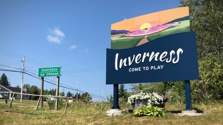 A developer has put a halt to an 80-unit housing project in the Cape Breton community of Inverness, saying the county still hasn't provided sewer and water hookup costs after two years. Inverness town sign