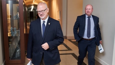 Manitoba Education Minister Kelvin Goertzen, left, and Manitoba Chief Provincial Public Health Officer Dr. Brent Roussin walk to a news conference in the Manitoba Legislative Building. COVID Mba 20200813