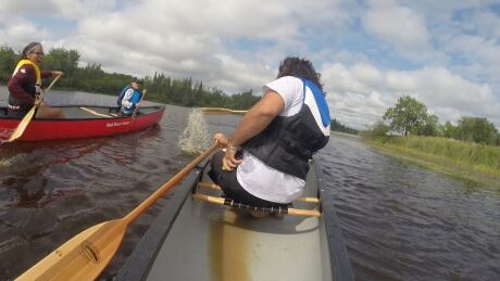 Waterways Recreation director Mo Crossman-Serb leads a convoy of youth in canoes to the rapids on the Black River. Waterways