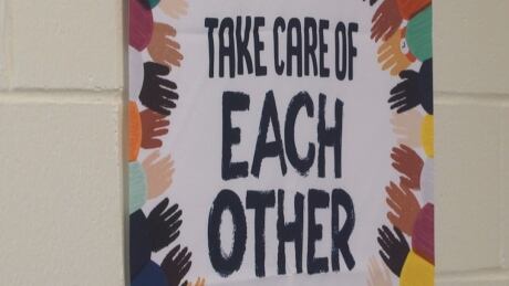 There are signs along the walls, and on the floor, throughout the school to remind students to physically distance. school covid-19 tour