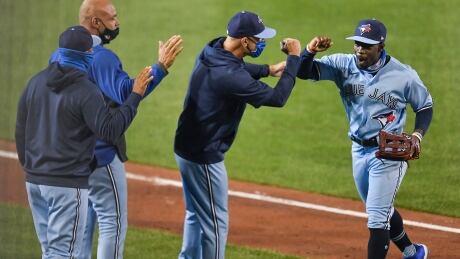 Toronto outfielder Jonathan Davis, right, celebrates with teammates after the Blue Jays' 2-1 win over the New York Yankees on Tuesday. Yankees Blue Jays Baseball