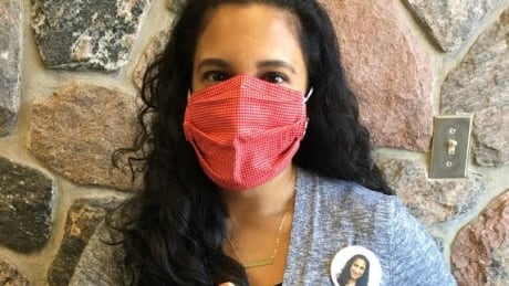 Anjana Kipfer of the Waterloo Public Library demonstrates what the button project is all about: The library will put a picture of a person's face on a button so they can wear it at work and people can see what they look like without a mask. The project is currently for educators, child care workers, staff at long-term care facilities and other caregivers. Anjana Kipfer waterloo public library button project