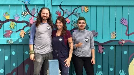 From left to right, Wallace Gillard, Laura-Leigh Gillard and Raven Debassige in front of the revitalized Louis Street mural in Sudbury. Louis Street Mural