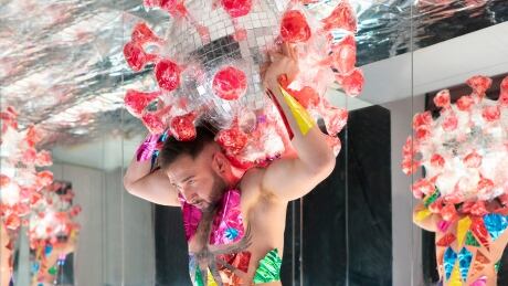 One photo showing DJ Daniel Stilla carrying the disco ball coronavirus on his shoulders like Atlas holding up the world caught a lot of attention, Dumont said. Michel Dumont installation