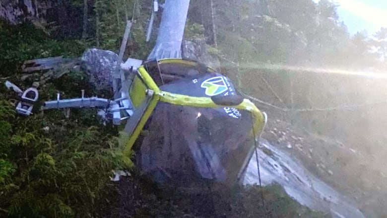 smashed gondola car lies on ground