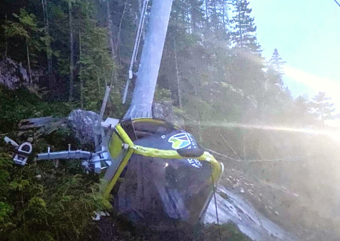 smashed gondola car lies on ground