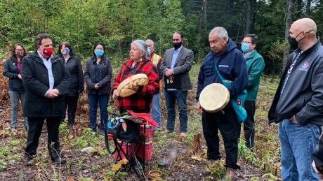 MP Marc Serre (left) greets residents of Atikameksheng Anishnawbek at a federal funding announcement. Atikmeksheng Anishnawbek