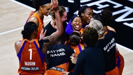 Phoenix's Shey Peddy is mobbed by teammates after hitting a 3-point buzzer beater to defeat the Washington Mystics and send the Mercury on to the second round of the WNBA playoffs on Tuesday. peddy-shey-091520