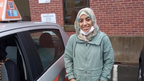 In this photo from the Atlantic Driving Academy's FaceBook page, a new driver celebrates passing her road test earlier this month. Laura Sears, a supervisor at the school, says it can now take up to two months to book a road test. New driver