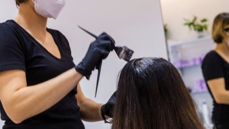 A Thetford Mines hairdresser, not seen in this photo, says she wore a mask on the job and went home as soon as she had symptoms. Virus Outbreak Italy Reopening