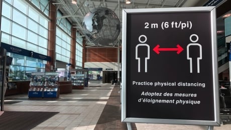 Signs for physical distancing are shown in the Halifax airport. Starting Sept.23, the airport joins 10 others across Canada to screen travelers for temperature. Halifax airport