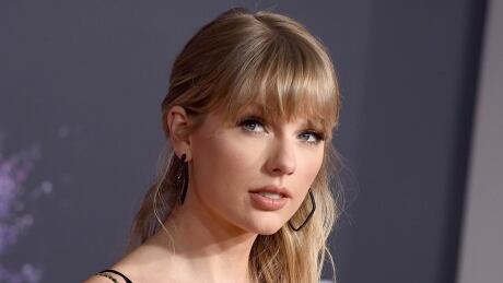 This Nov. 24, 2019 file photo shows Taylor Swift at the American Music Awards in Los Angeles. A Texas man is sentenced to 30 months in prison after pleading guilty to stalking and sending threatening letters about Swift. A federal judge in Nashville, Tennessee handed down the sentence Wednesday to Eric Swarbrick, who sent over 40 letters and emails to Swift's former record label in 2018, asking the CEO to introduce him to Swift. Over time the letters became more violent and threatening. People Taylor Swift Stalker
