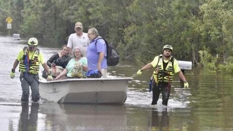 CORRECTS DATE TO SEPT. 17 NOT AUG. 17 Members of a citizen response team from Indiana assist in high water rescue of residents, Thursday, Sept. 17, 2020 in Pensacola, Fla. Homeowners and businesses along the soggy Gulf Coast have begun cleaning up in the wake of Hurricane Sally, even as the region braces for a delayed, second round of flooding in the coming days from rivers and creeks swollen by the storm's heavy rains. CORRECTION Tropical Weather