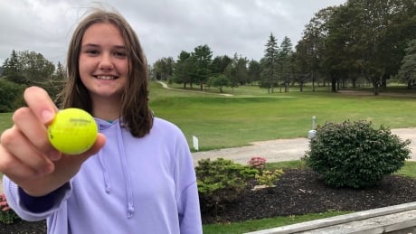 Haley Palmer with the beat-up golf ball she used to hit her hole-in-one. 'I don't like attention,' she said, despite getting a lot of it following her hole-in-one. Haley Palmer