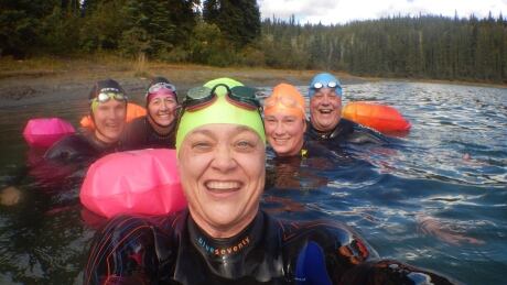 Sophia Marnik, front, with members of the 'wild swimmer' group she started in Whitehorse. The group aims to swim in as many frigid Yukon lakes as they can each summer. Yukon wild swimmers