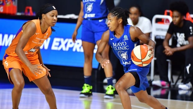 Minnesota's Crystal Dangerfield drives to the basket guarded by Phoenix's Shey Peddy in the first quarter of the Lynx's 80-79 second-round playoff win over the Mercury on Thursday. dangerfield-crystal-091720