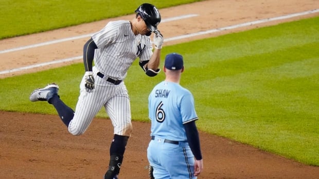 New York outfielder Giancarlo Stanton rounds the bases after a home run during the Yankees' 10-7 win over the Toronto Blue Jays on Thursday. Blue Jays Yankees Baseball
