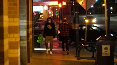 Richmond Row in London was quiet Thursday night after the health unit revealed more than 2 dozen Western students were infected with COVID-19. Young people in London