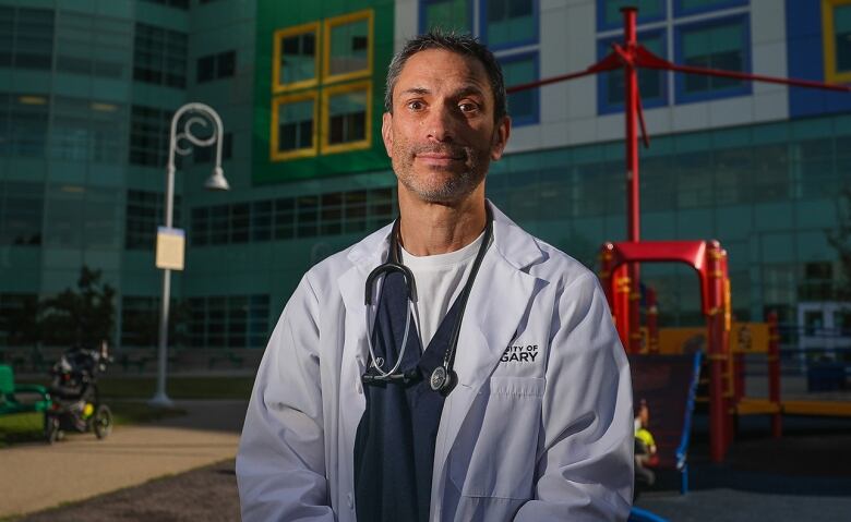 Dr. Stephen Freedman wears a white lab coat as he stands outside Alberta Children's Hospital.