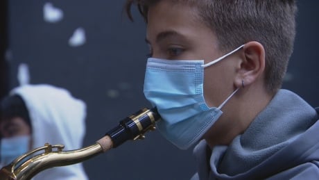 Students in band class at Sheldon Williams Collegiate in Regina must blow into their instruments through masks with a slit. Band class Sheldon Williams