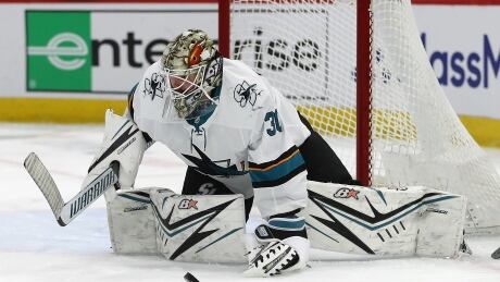 CHICAGO, ILLINOIS - MARCH 11: Aaron Dell #30 of the San Jose Sharks drops to make a save against the Chicago Blackhawks at the United Center on March 11, 2020 in Chicago, Illinois. 1212596567