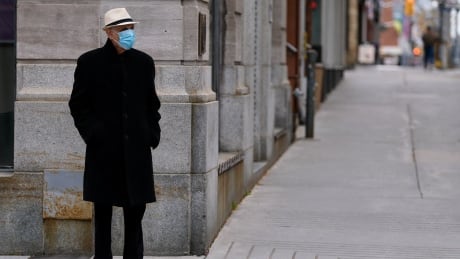 A pedestrian in a mask in downtown Ottawa Oct 22, 2020, during the COVID-19 pandemic. mask covid coronavirus ottawa
