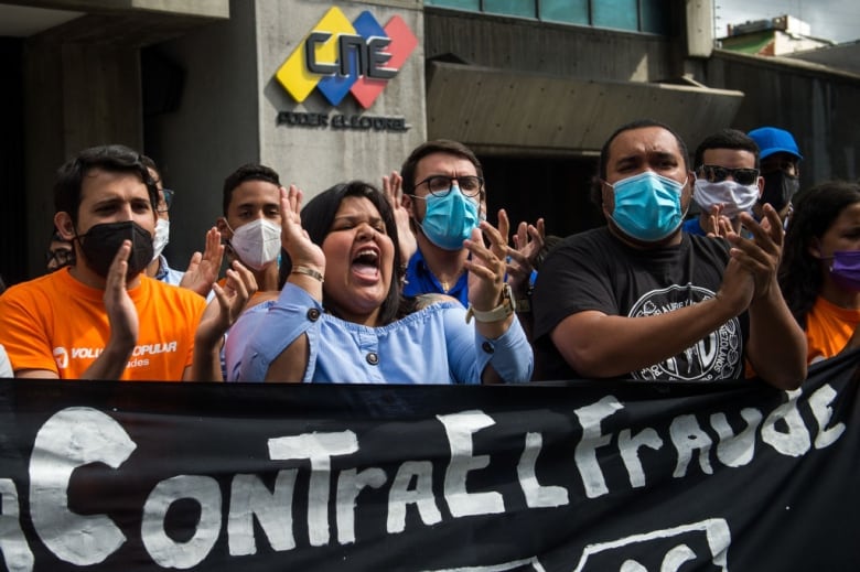 Opposition activist stage a protest, calling for a boycott of parliamentary elections, in front of the National Electoral Council headquarters in Caracas on Dec. 2. (Cristian Hernandez/AFP via Getty Images)