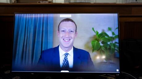 FILE - In this Oct. 28. 2020 file photo, Facebook CEO of Mark Zuckerberg appears on a screen as he speaks remotely during a hearing before the Senate Commerce Committee on Capitol Hill in Washington. (Michael Reynolds/Pool via AP) Congress Social Media