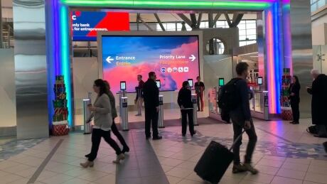 Passengers mill around near central security portal at Edmonton International Airport on Dec. 11, 2019. 89899
