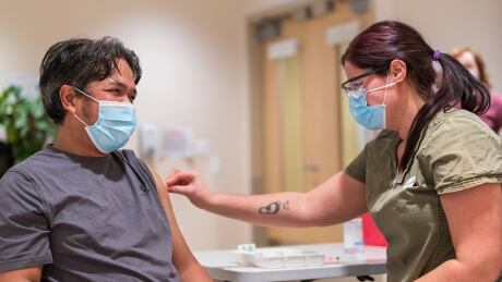 The third vaccine went to Jun Carpina, who works in the care facility. Yukon Government