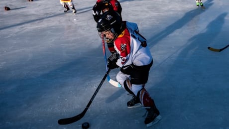 Minor hockey players play shinny along Ottawa's Rideau Canal in February 2020. In 2021, the outdoor hockey ritual has mostly been cancelled due to the COVID-19 pandemic. shinny-rideau-011221