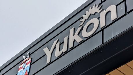The Yukon coat of arms (left) and a Yukon government logo attached to the Yukon legislative building in Whitehorse pictured on Nov. 13, 2020. Yukon logo