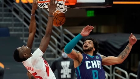 Toronto's Chris Boucher dunks over Charlotte's Miles Bridges during the second half of the Raptors' 111-108 win over the Hornets on Thursday. boucher-chris-011421