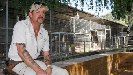Joseph Maldonado-Passage, also known as Joe Exotic, is seen at the zoo he used to run in Wynnewood, Okla. A federal judge in Oklahoma has ordered the new owners of the Oklahoma zoo featured in Netflix's Tiger King documentary to turn over all the lion and tiger cubs in their possession. Tiger King Zoo