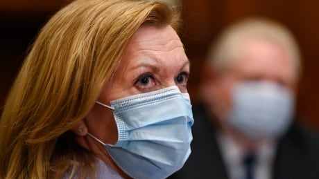 Ontario Health Minister Christine Elliott listens as Ontario Premier Doug Ford gives an update regarding the Ontario COVID-19 vaccine during the COVID-19 pandemic in Toronto on Tuesday, January 5, 2021. COVID Ont Ford Vaccine 20210105