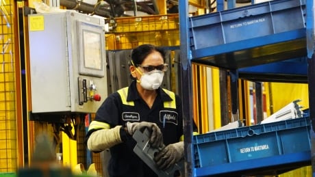 Auto workers on assembly line at Martinrea, Vaughan, Ontario. Auto parts manufacturer Martinrea, Vaughan, Ontario.