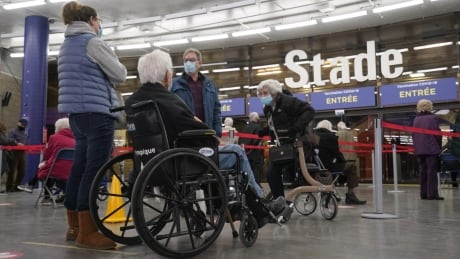 People line up for the COVID-19 vaccine at Montreal's Olympic Stadium on Monday. Mass COVID-19 vaccination campaign underway in Montreal Image 1