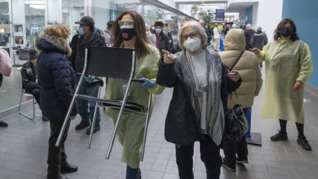 Officials say more chairs and staff will be deployed to mass vaccination sites. Pharmacies to start administering vaccines in mid-March as tracking coronavirus variant remains top priority Image 1
