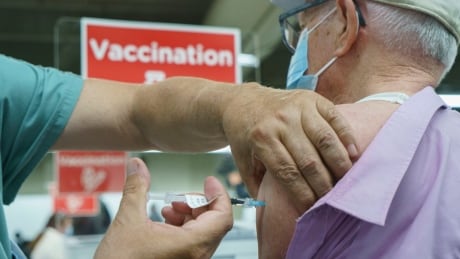 Seniors receive their COVID-19 vaccine at a clinic at Olympic Stadium marking the beginning of mass vaccination in the Province of Quebec based on age in Montreal, on Monday, March 1, 2021. THE CANADIAN PRESS/Paul Chiasson COVID Que 20210301