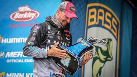 Jeff Gustafson holds Bassmaster Elite trophy Sunday, Feb. 28,2020, after winning his first Bassmaster tournament on the Tennessee River. Jeff Gustfason