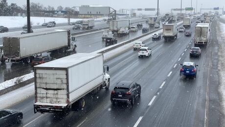 Traffic on slushy road or highway in Toronto on 19 Feb 2021 with wet snow., shot from above. Snowfall Friday