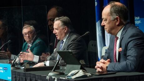 Quebec Health Director Horacio Arruda, left, Quebec Premier Francois Legault and Health Minister Christian Dube, right, speak to the media at the COVID-19 press briefing on Wednesday in Montreal COVID Que 20210303