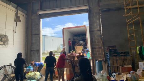 Unloading shipper container donated goods from P.E.I. to Bahamas
