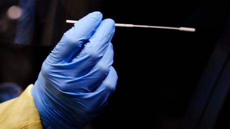 A nurse uses a swab to perform a test on a patient at a drive-in COVID-19 clinic in Montreal, on Wednesday, October 21, 2020. Ontario Coronavirus 20201104