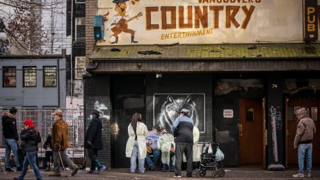 Vancouver Coastal Health workers administer COVID-19 vaccinations in front of a bar on East Hastings in Vancouver, British Columbia on Friday, February 26, 2021. COVID-19 VACCINATIONS